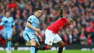 Ashley Young of Manchester United evades Samir Nasri of Manchester City during their Premier League match at Old Trafford on Sunday. Young would score the equaliser as United would go on to win 4-2. Alex Livesey / Getty Images