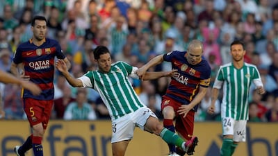 Barcelona’s Andres Iniesta and Real Betis’ Alvaro Cejudo in action. Marcelo del Pozo / Reuters