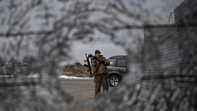 A Ukrainian serviceman stands at a check point in the vilage of Velyka Dymerka east of Kyiv. AFP