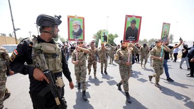 Supporters of Iran-backed Iraqi Shiite Popular Mobilisation Forces carry the pictures of their comrades who were killed in a US air strike near the Iraqi border with Syria. EPA