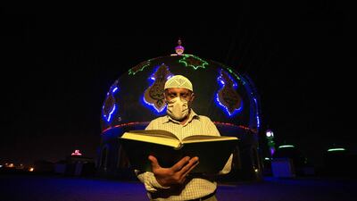 An Iraqi worshipper reads the Quran in front of the Musawi grand mosque in Basra. AFP