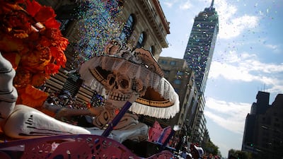 A Catrina figure is pushed by revellers during the annual Day of the Dead parade in Mexico City. Reuters