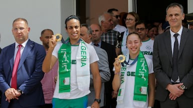 Algerian boxer Imane Khelif and gymnast Kaylia Nemour show off their Olympic gold medals as they arrive at Algiers airport on Monday, August 12, 2024. Reuters