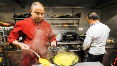 A kitchen worker plates up a curry dish in the kitchen of the Indo Indian fine dining restaurant in Chobham, U.K., on Wednesday, Nov. 14, 2018. Almost two decades after chicken tikka masala was unofficially declared Britain's national dish, pro-Leave politicians promised restaurants higher inflows from South Asia with easier visa rules, shutting the door on European workers, allowing lower salary-thresholds to hire overseas staff and even regularizing undocumented workers. Photographer: Luke MacGregor/Bloomberg