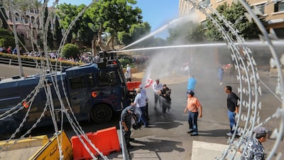 Lebanese riot policemen clash with retired army officers and soldiers where they were trying to enter the government palace during a demonstration in Beirut, Lebanon. EPA