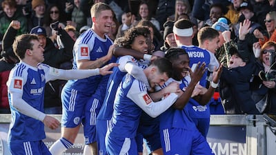 Macclesfield's Isaac Buckley-Ricketts celebrates with teammates after scoring. AFP