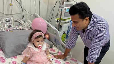 Dr Vivek Mundada, a consultant paediatric neurologist at Medcare Royal Specialty Hospital, with young patient, Mirha. photo: Medcare Royal Specialty Hospital.
