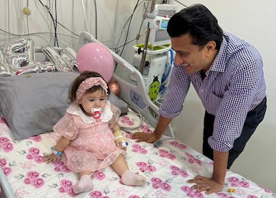 Dr Vivek Mundada, a consultant paediatric neurologist at Medcare Royal Specialty Hospital, with young patient, Mirha. photo: Medcare Royal Specialty Hospital.
