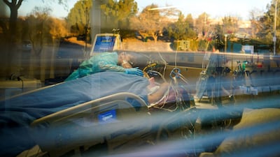 Nurse Carolina Garcia takes care of her father, Jose Garcia, who is intubated and sedated at Memorial Medical Centre in Las Cruces, New Mexico, US. Reuters