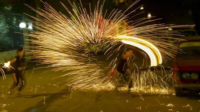 Egyptians play with fire works as they celebrate Ramadan in Cairo, Egypt. Amr Nabil / AP Photo