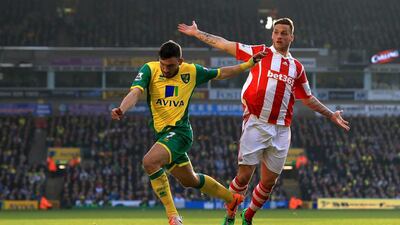 Robert Snodgrass of Norwich City goes past Geoff Cameron of Stoke City during their Premier League match at Carrow Road on March 8, 2014 in Norwich, England. Matthew Lewis/Getty Images