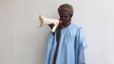 A crier in the royal court poses for a photograph in the courtyard of the emir’s palace in Kano.