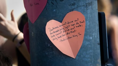 Paper hearts with messages of support are visible at an intersection next to the Chabad of Poway synagogue. EPA