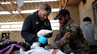 Former US Marine Pete Reed, seen here offering medical aid in Iraq in 2016, was killed in the city of Bakhmut, Ukraine, on February 3, 2023. AFP