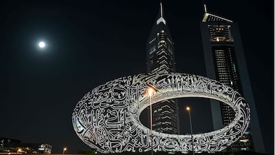 A full moon also known as the "Blood Moon" is seen above Future mUseum in Dubai on March 3, 2026. In the first two days of the war in the Middle East, Iran launched nearly 400 missiles and around 1,000 drones towards the United Arab Emirates, Kuwait, Bahrain, Qatar and Jordan, said Mintel World, which specialises in open-source intelligence. (Photo by Giuseppe CACACE / AFP)