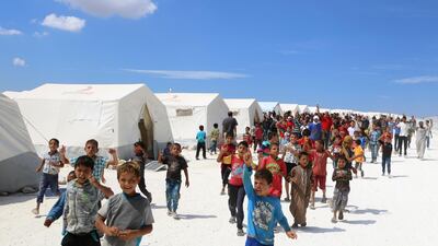 Displaced Syrians take part in a protest against the regime and its ally Russia at a camp near the border crossing with Turkey in the northern Idlib province. Aaref Watad / AFP