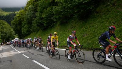 Richard Carapaz of Ecuador, right, and Slovenia's Tadej Pogacar, wearing the overall leader's yellow jersey, climb Tourmalet pass.