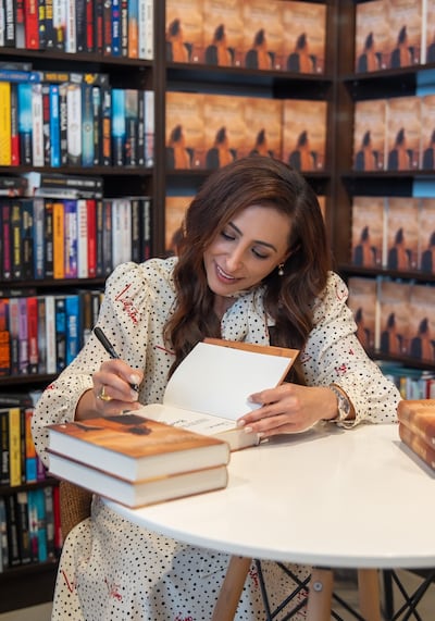 Sheikha Bodour Al Qasimi signs copies of Let Them Know She Is Here: Searching for the Queen of Mleiha at Ksiegarnia Korekty bookshop in Warsaw. Photo: Sharjah Book Authority