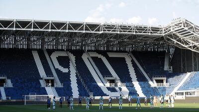 Players observe a minute of silence to honor the victims of coronavirus ahead of the match. AP