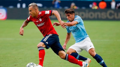 Bayern Munich's Rafinha vies for the ball with Manchester City's Patrick Roberts. AFP
