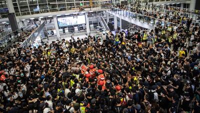 Anti-government protesters surround a man they accuse of being a mainland Chinese police officer during a sit-in against police violence in Hong Kong Chek Lap Kok International Airport. EPA