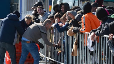 Migrants wait in line for food and water distribution at the port of Mytilene on the northeastern Aegean island of Lesbos, Greece. AP Photo