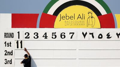 A man marks on the board the winner Lady Parma ridden by Richard Mullen of the Orient Irrigation Service race.