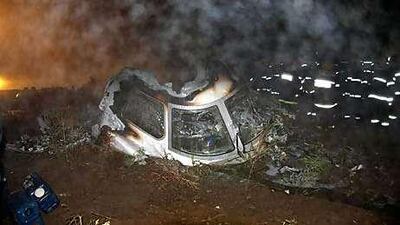 Rescuers search for bodies of victims beside the wreckage of a crashed passenger plane in Yichun, in northeast China's Heilongjiang Province.