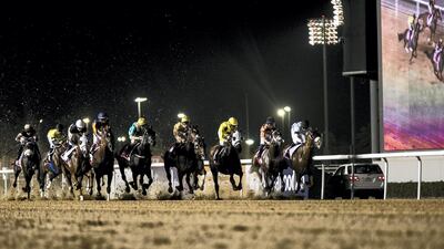 Jockeys start the Emirates.com Handicap 2,000m dirt race at Meydan Racecourse for the first race meeting. Reem Mohammed / The National