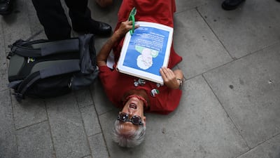 A demonstrator lies on the pavement outside Westminster Magistrates' Court. Getty Images