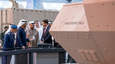 Sheikh Mohamed, Lt Gen Al Mazrouei and Faisal Al Bannai, chief executive of UAE defence conglomerate Edge, visit a pavilion at the exhibition