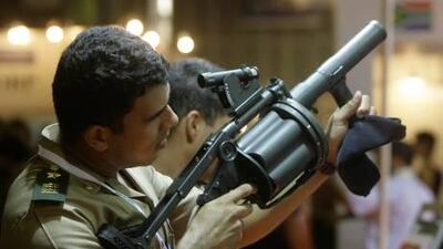 A Brazilian soldier checks a weapon at the Latin America Aerospace and Defense show in Rio de Janeiro. A proposed global arms treaty would regulate all conventional weapons from small arms to tanks, warships and missile systems.