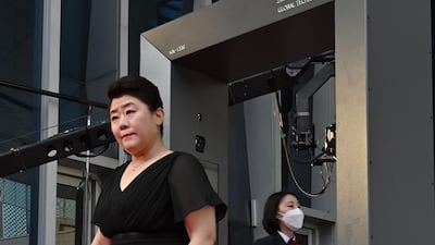 Actress Lee Jeong-eun walks through a thermal camera system to check her body temperature as she arrives on the red carpet. AFP