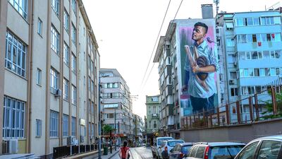 A woman walks in a empty street of Kadikoy, in Istanbul, during a four day curfew. Since the start of the outbreak, Turkey has had all-day weekend curfews in 31 cities including Istanbul and the capital Ankara. AFP
