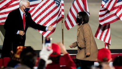 Vice President Mike Pence motions to his daughter Audrey Pence to walk on stage after he spoke during a campaign top on behalf of President Donald Trump on Wednesday, Oct. 28, 2020, in Flint, Mich. (Nicole Hester/Ann Arbor News via AP)