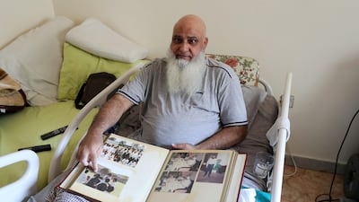 Mohammed Ishaq shows some old newspaper clippings from his playing career. Ishaq represented the UAE at the 1996 Cricket World Cup.