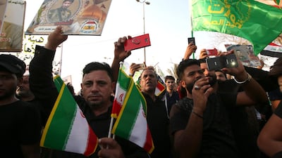Supporters of Iraqi Shiite group Popular Crowd Forces carry the Iranian flag during a demonstration in Basra. EPA
