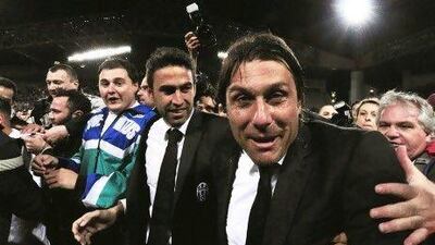 Juventus coach Antonio Conte, right, celebrates at the end of an Italian Serie A football match against Cagliari at the Nereo Rocco stadium in Trieste. Alberto Pizzoli / AFP