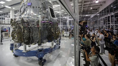 Attendees take pictures of the Crew Dragon spacecraft. Bloomberg