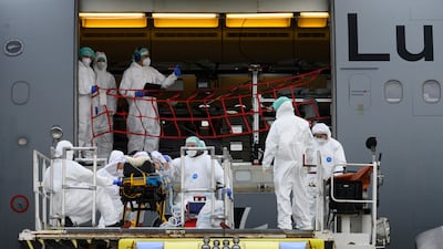 A coronavirus patient is transported by medical personnel to a German Air Force A310 MedEvac aircraft at Dresden International Airport. AP