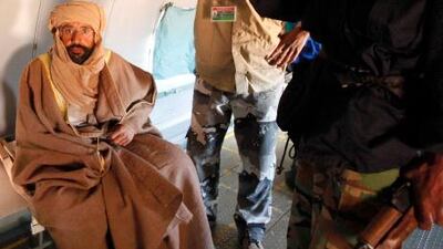 Saif Al Islam Qaddafi sitting in a plane in Zintan Saturday after his capture. He told Reuters that he was feeling fine after being captured by some of the fighters who overthrew his father.