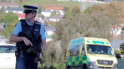 Armed police stands at the scene of a shooting incident following a routine traffic stop in Auckland. New Zealand Herald via AP