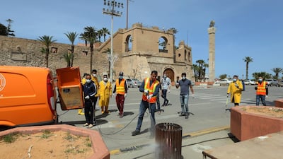 Libyan workers disinfect a street in the centre of the capital Tripoli on Wednesday. AFP