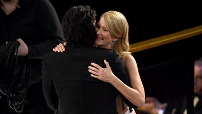 Adam Driver, left, congratulates Laura Dern, winner of the award for best performance by an actress in a supporting role for "Marriage Story" at the Oscars on Sunday. AP