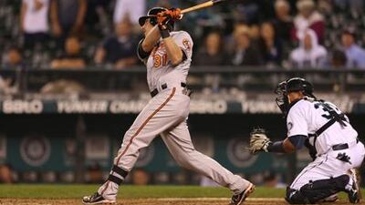 Baltimore's Taylor Teagarden hits a single in the 18th inning against Seattle