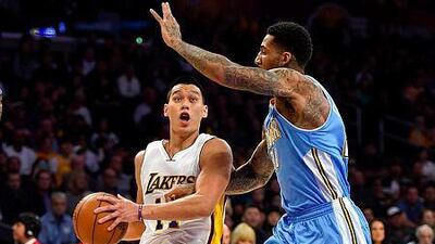 Los Angeles Lakers guard Jeremy Lin, left, drives on Denver Nuggets forward Wilson Chandler, right, in the first half of an NBA basketball game, Sunday, Nov. 23, 2014, in Los Angeles. (AP Photo/Gus Ruelas)