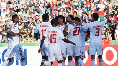 Time to celebrate as the UAE players mob Omar Abdulrahman after his cross led to the Bahrain own goal that handed the UAE the lead.