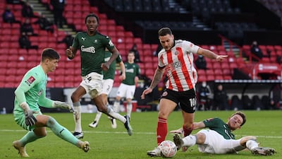 Sheffield United's Billy Sharp evades the challenge of Will Aimson on his way to scoring his team's second. Getty