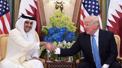 The Qatari emir Sheikh Tamim Bin Hamad Al Thani shakes hands with US president Donald Trump during a bilateral meeting in the Saudi capital Riyadh on May 21, 2017. Mandel Ngan / AFP