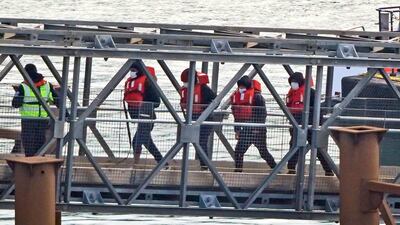 Migrants at a processing centre in Dover, Kent, after being rescued from a small boat in the English Channel on February 9. PA
